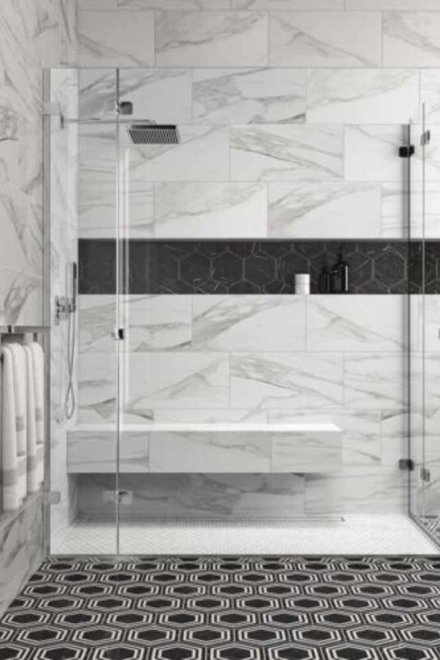 geometric black floor tile in bathroom with marble finished shower